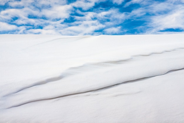 White snow against the blue sky