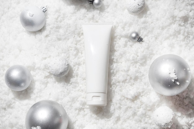 White snow background with lifestyle, cosmetic makeup bottle lotion cream product mockup with beauty fashion skincare for merry christmas festival gift