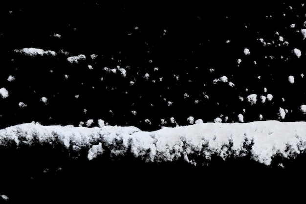 White snow isolated on a black background. Winter elements for design. High quality photo