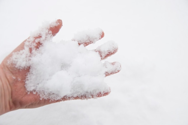 White snow in the palm of your hand and on your fingers