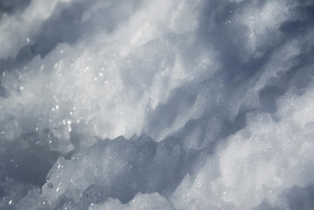 White snow surface with shadows in sunlight at winter