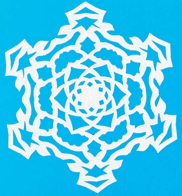 White snowflake on blue paper