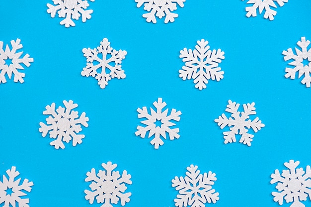 white snowflakes on a blue background close up