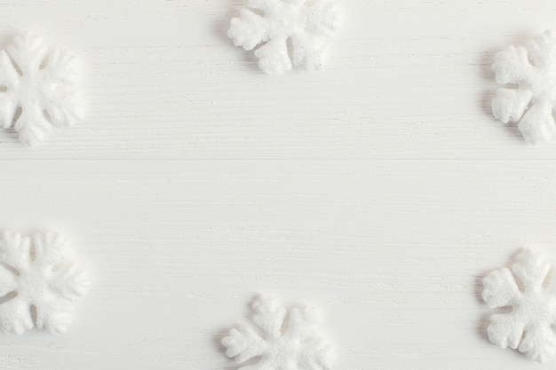 White snowflakes on a wooden table 