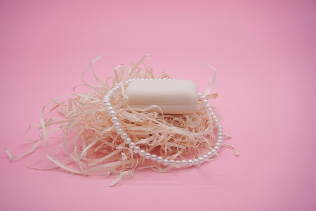 White soap bar isolated on pink background. White soap.