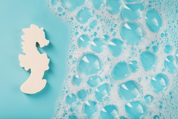 White soap in the shape of a seahorse with foam