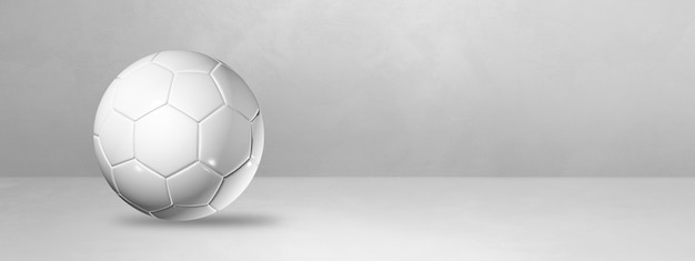 White soccer ball isolated on a blank studio banner.