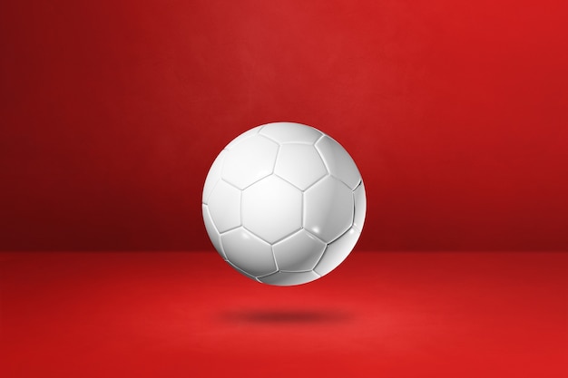 Foto pallone da calcio bianco isolato su uno sfondo rosso. illustrazione 3d