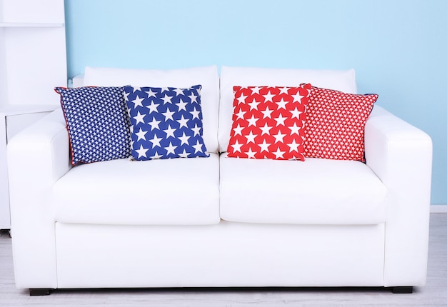 White sofa with colorful pillows in room