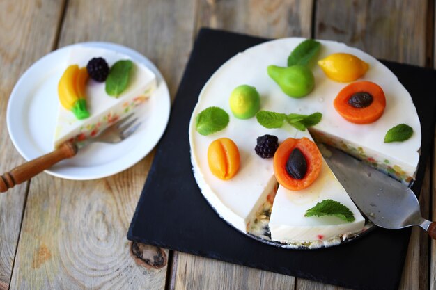 White souffle cake with marmalade fruits