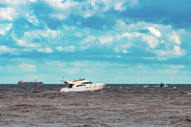 White speed boat moving fast to the Baltic sea. Water sport