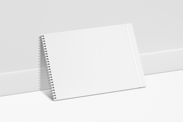 a white spiral notebook on a white surface