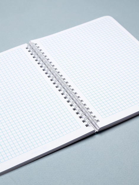 White spiral notepad isolated on blue background Include clipping path of the border of notepad