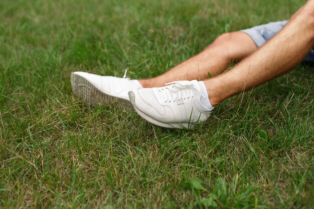 White sport shoes on grass