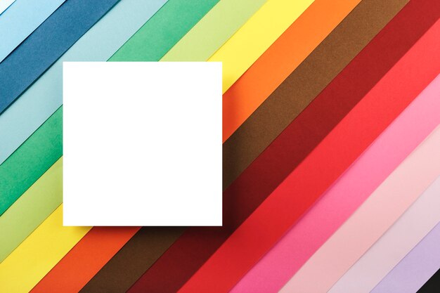 White square on a background of many colored cardboards