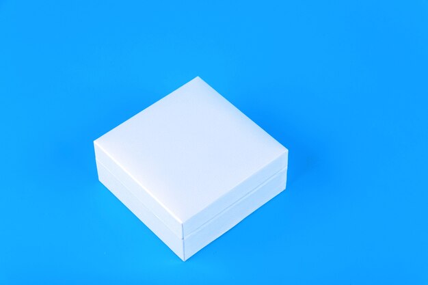 White square box on blue surface