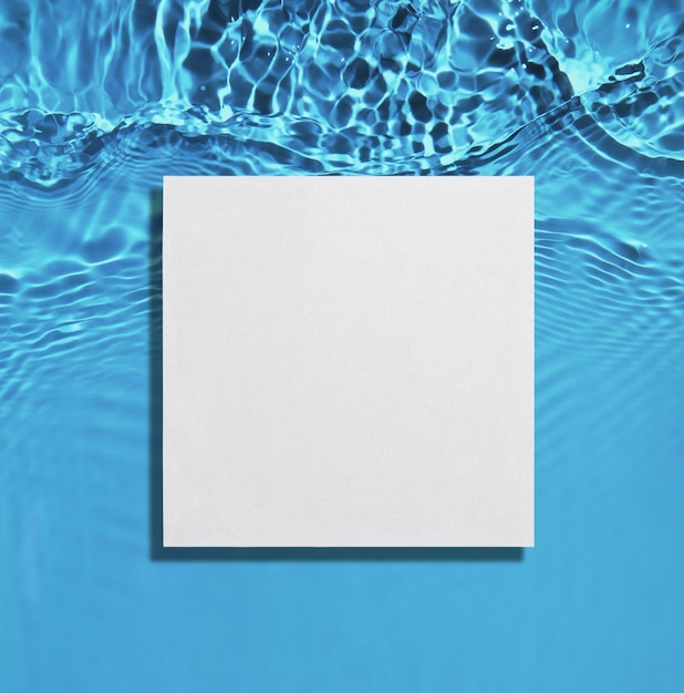 White square podium on the blue water surface background Flat lay copy space