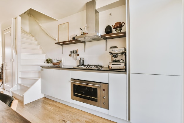 White staircase next to the kitchen