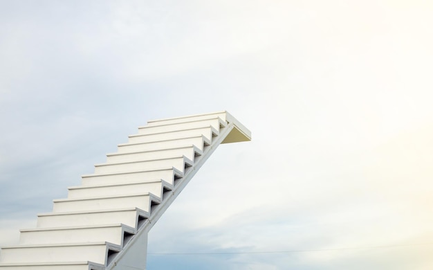 A white staircase stretches up the horizon that means to be
success or go to heaven