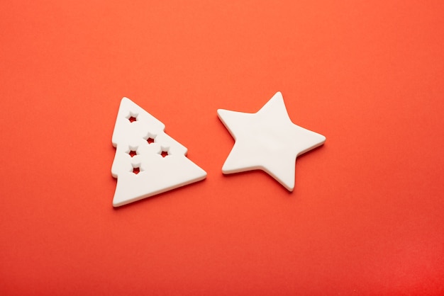 White star and Christmas tree made of ceramics on a bright red background