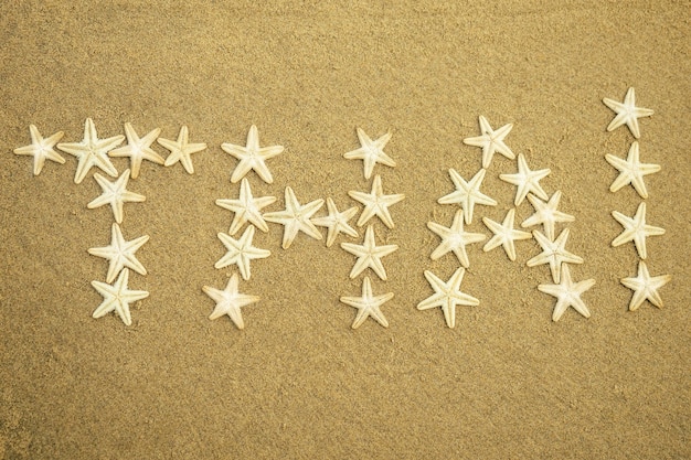 White starfish inscription of the word Thailand on the sand. Thailand on the sand from the stars of the sea. concept of vacation and travel.