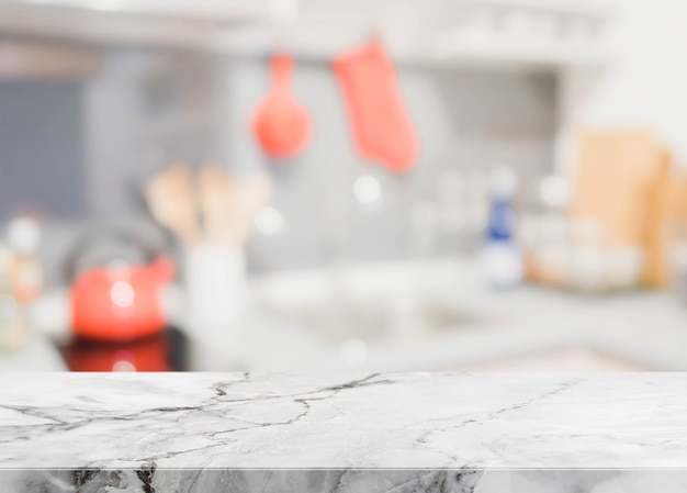 White stone table top and blurred kitchen interior background - can used for display or montage your products.