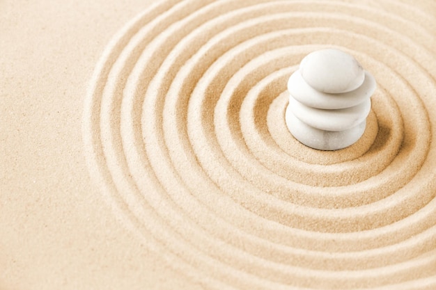 White stones pile in the sand zen japanese garden background\
scene