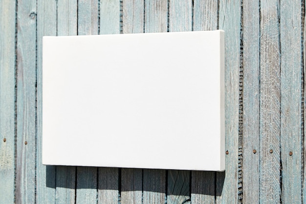 Photo white stretched canvas mockup on wooden wall