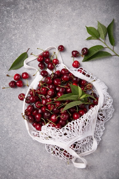 White string bag with fresh cherry