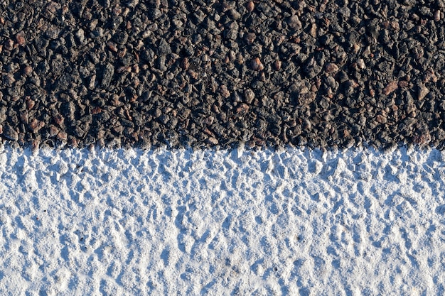 White stripe on an asphalt road to differentiate traffic vehicles