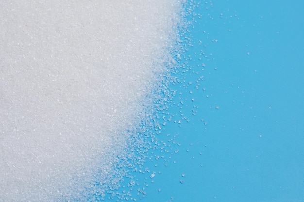 White sugar on blue background