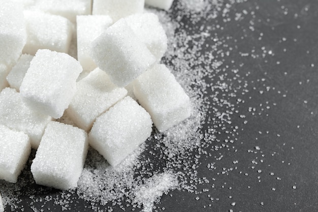 White sugar cubes over black  close up