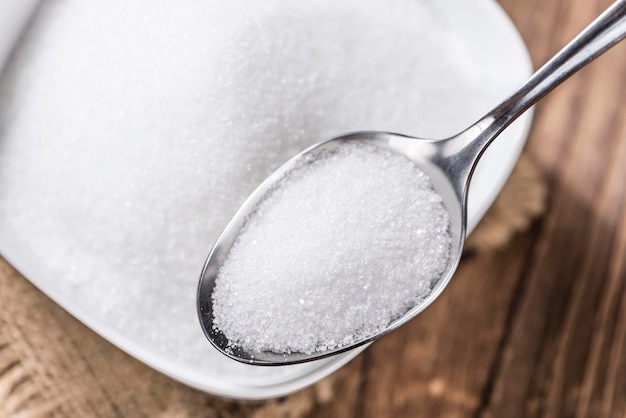 Photo white sugar on a spoon