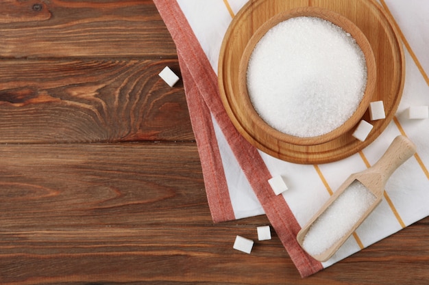 White sugar on the table on a light background closeup