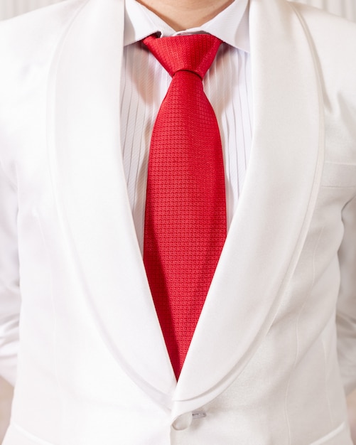 White suit and red necktie