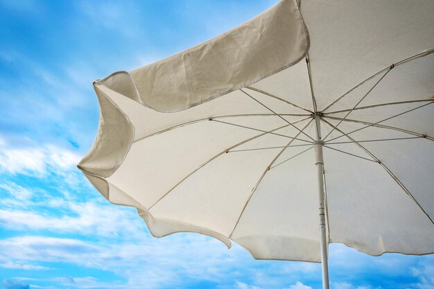 A white sunshade at the blue sky background