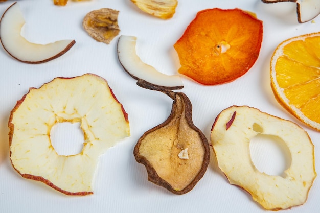 A white surface with apple slices and a hole in the middle that says " o ".