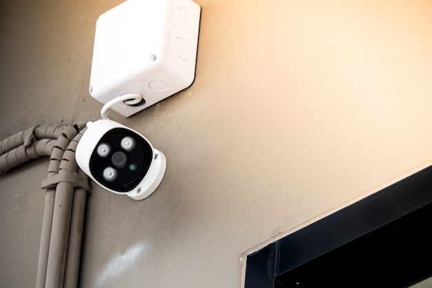 white surveillance camera on wall, concept security city.