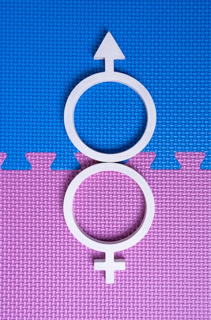 Photo white symbols of man and woman form the sign of supernaturals, superstraight. vertical foto