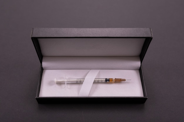 White syringe in a black cover on