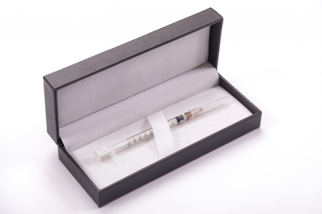 White syringe in a black cover