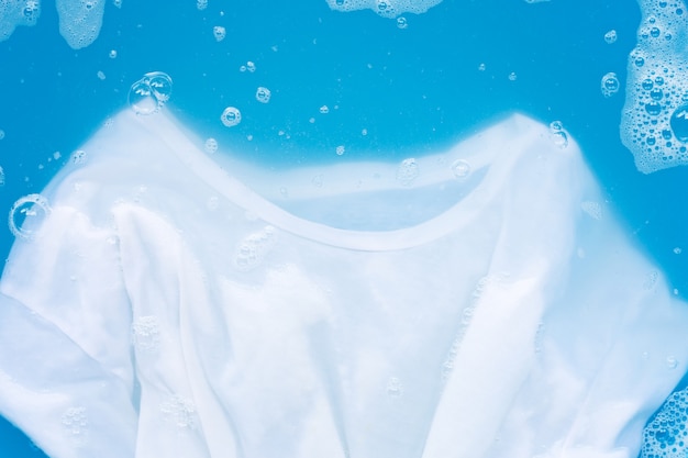 White T - shirt soak in powder detergent water dissolution, washing  cloth. 