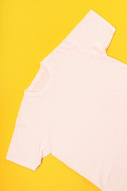 White t-shirt with space for print on yellow background