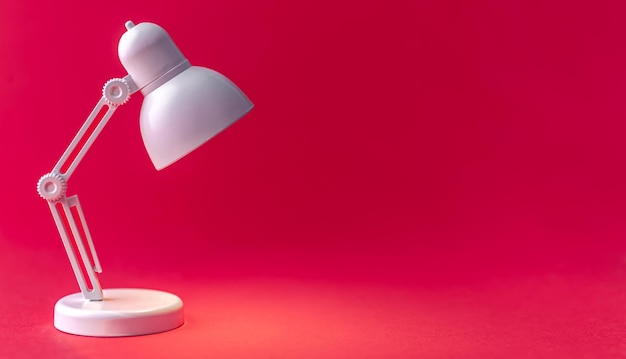 White table lamp on a Viva Magenta background copy space