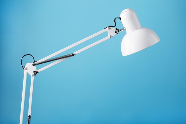 White table office lamp on blue background with