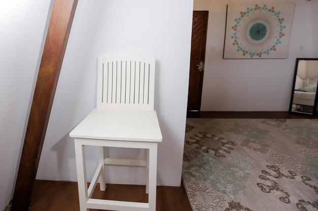 A white table in a room with a painting on the wall