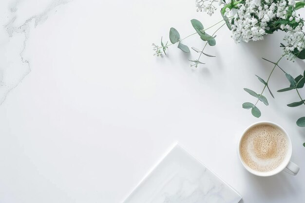 a white table with a cup of coffee and a picture of flowers