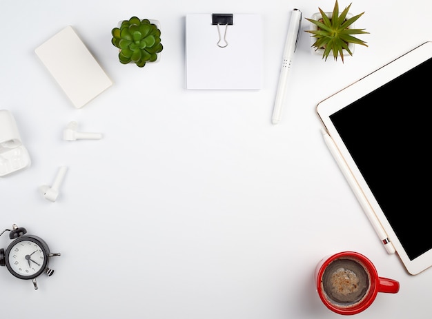 White table with electronic tablet, blank business cards