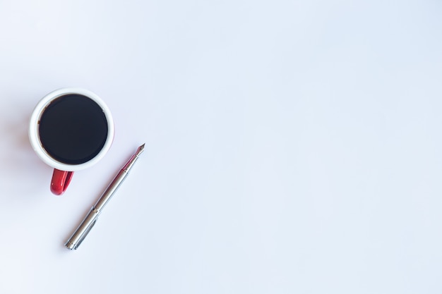 White table with pen and coffee cup