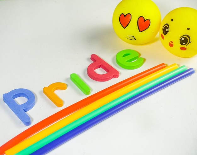 A white table with a yellow ball and the word pride on it